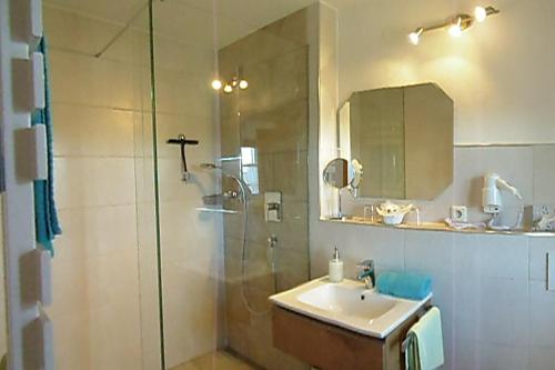 a bathroom with a glass shower and a sink at Taffenreutherhof in Achenmühle
