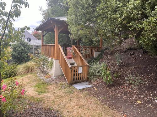 a wooden deck with a gazebo in a yard at Wanaka Springs Lodge in Wanaka