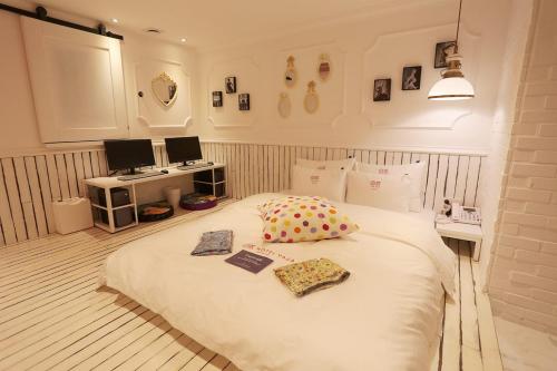 a bedroom with a large white bed with two pillows at Hotel Yaja Jongno in Seoul