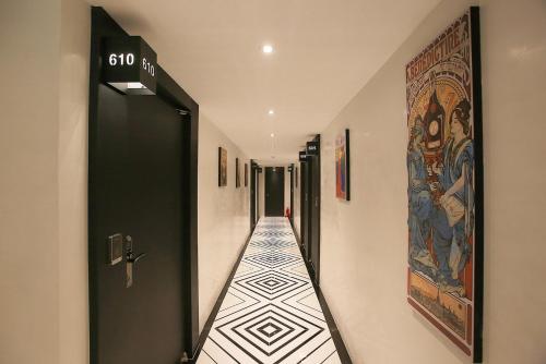 a hallway with a tile floor with a painting on the wall at Hotel Yaja Jongno in Seoul