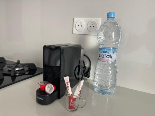 a bottle of water next to a television and a bottle of water at Luxury Apartments in Tangier