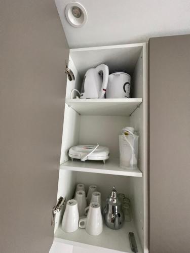 a cupboard filled with lots of white appliances at Luxury Apartments in Tangier