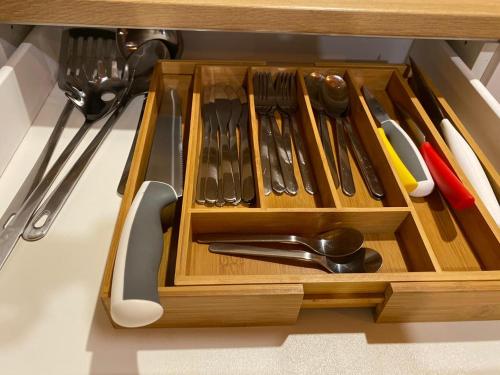 a wooden drawer with utensils in a kitchen at شاليه أرياف Chalet Aryaf Yanbu in Yanbu