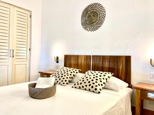 a bedroom with a bed with black and white pillows at The Sanctuary in Santo Domingo