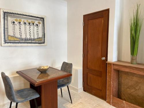 a dining room with a wooden table and chairs at Paseo Colonial - Sanctuary #2 in Santo Domingo