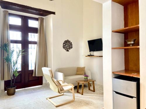 a living room with a chair and a couch at Paseo Colonial - Sanctuary #2 in Santo Domingo
