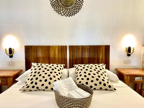 a bedroom with a bed with black and white pillows at The Sanctuary in Santo Domingo