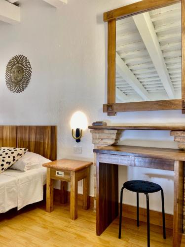 a bedroom with a bed and a table and a fireplace at Paseo Colonial - Sanctuary #2 in Santo Domingo