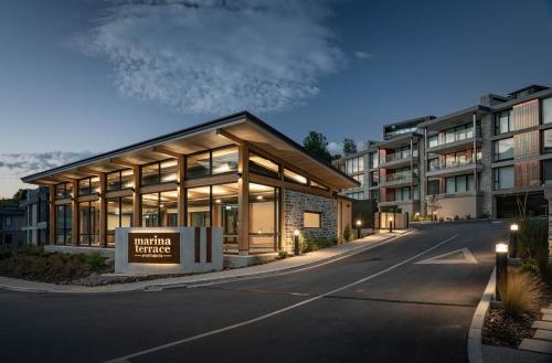 a building with a sign in front of a building at Marina Terrace Apartments, Wanaka in Wanaka