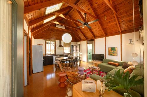 a living room with a couch and a table at Seahorse Manor, The South Coast Sandcastles in Huskisson