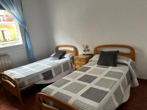 two beds sitting next to each other in a room at Pension Vista Alegre in Bilbao