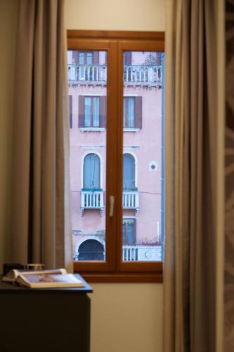 a window with a view of a building at Palazzina RIVA in Venice