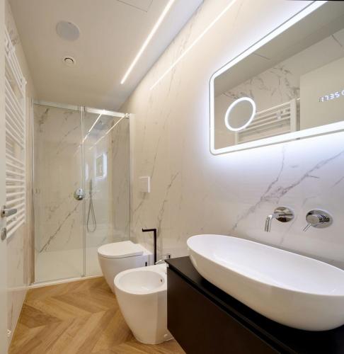 a bathroom with a sink and a shower and a toilet at Palazzina RIVA in Venice
