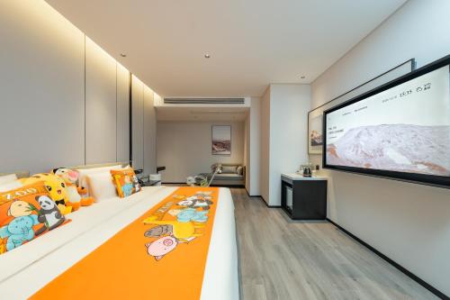 a living room with a large screen in a room at Atour Hotel Guangzhou Pazhou Exhibition Center Information Port-Free shuttle bus to Canton Fair in Guangzhou