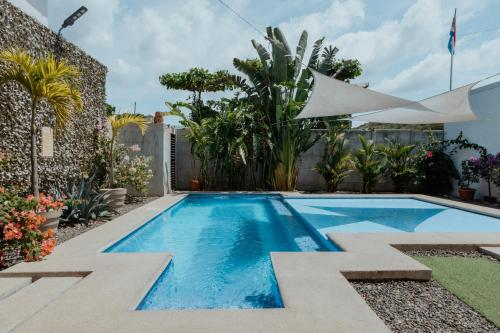 a swimming pool in the backyard of a house at Private home with resort style swimming pool in Jacó