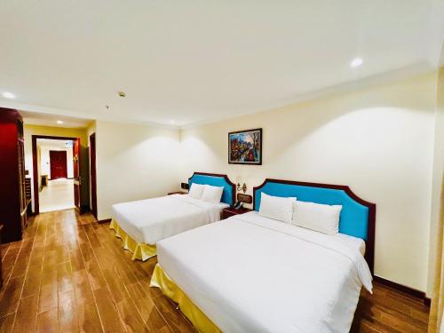 a hotel room with two beds in it at CALYSSA HOTELS & VILLAGE in Khu Chi Lăng