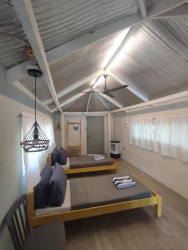 a room with two beds and a table at Caliraya Mountain Lake Resort in Cavinti