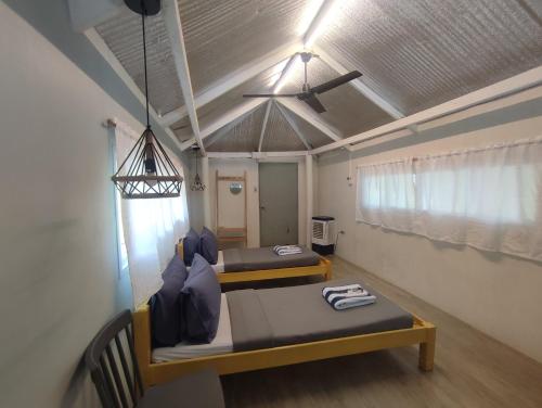 a room with two beds and a ceiling fan at Caliraya Mountain Lake Resort in Cavinti