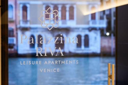 a sign for a villa riva seen through a window at Palazzina RIVA in Venice