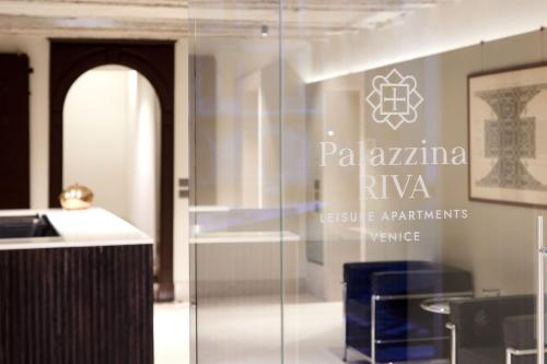 a glass door with a sign in a room at Palazzina RIVA in Venice