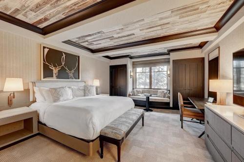 a large bedroom with a large bed and a desk at Ritz-Carlton Bachelor Gulch in Avon