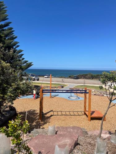 a view of a playground with the ocean in the background at Coastal Country Retreat, Spa, fireplace, pet friendly, FREE WIFI wine & chocolates, Kilarney, 10 minutes to Phillip Island in Kilcunda