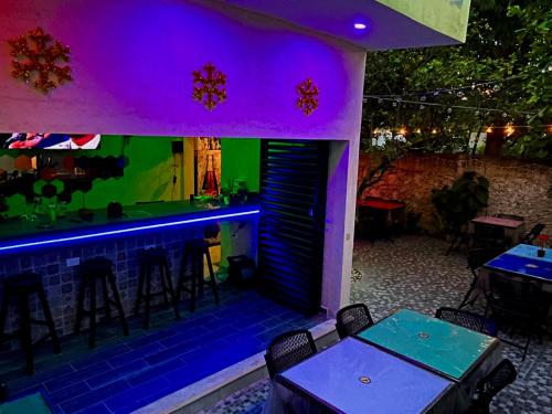 a bar with purple and green lighting in a restaurant at Casa Fausto’s in Azcorra