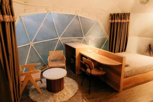 a bedroom with a desk and a bed with a desk at 150 Peakway Mountain Resort in Dalaguete