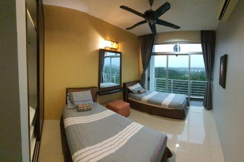a hotel room with two beds and a window at Sky Residence -3 Bedrooms Condo at Cinta Sayang, Sungai Petani in Sungai Petani
