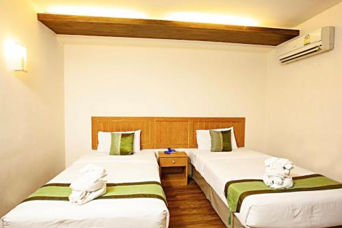 Postel nebo postele na pokoji v ubytování TM Land Hotel