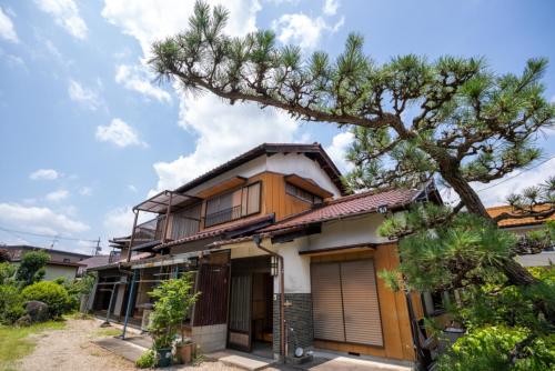 a house with a tree in front of it at Hanareya Hyō - Vacation STAY 49547v in Nakatsugawa