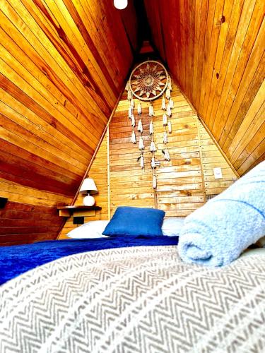 a bedroom with a bed with a wooden ceiling at Airport Traveler's home. in Alajuela City