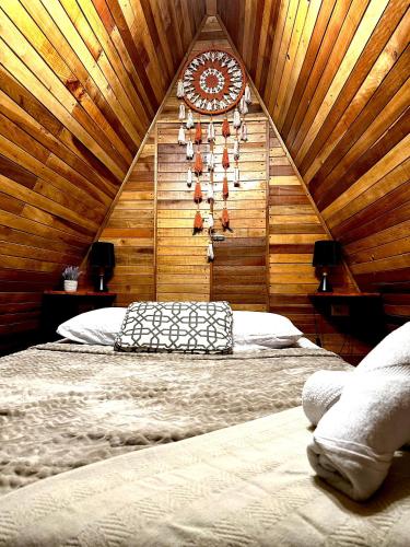 a bedroom with a large bed with a clock on the wall at Airport Traveler's home. in Alajuela City