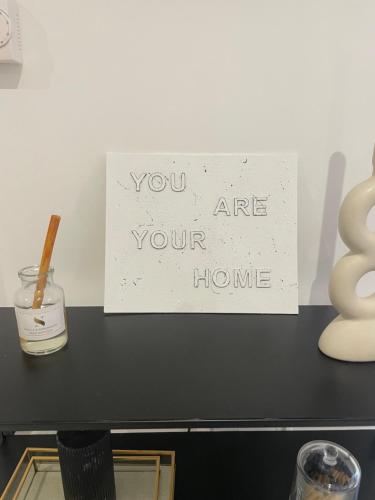 a sign that says you are your home on a table at Room in Bourne in Lincolnshire