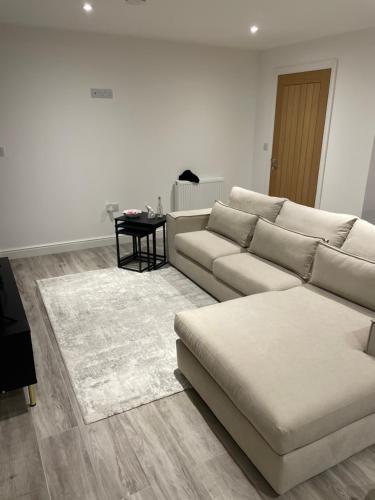 a living room with a couch and a table at Room in Bourne in Lincolnshire