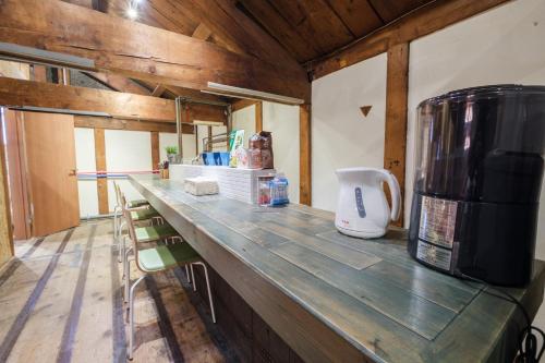 a kitchen with a counter with a coffee maker on it at Stone Lodge 小樽 in Kita-hamachō