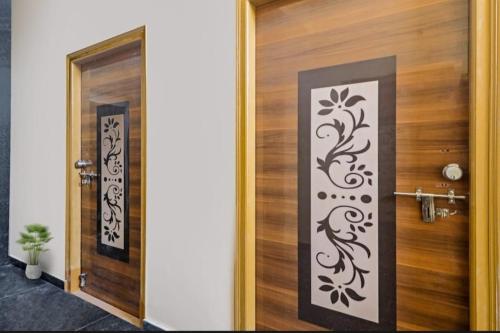 a wooden door with a black and white design on it at hotel high 5 in Hyderabad