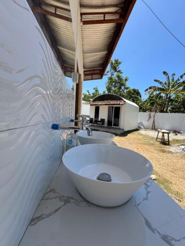 a bathroom with a white sink on a counter at Lily Paradise in Siquijor