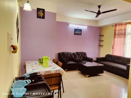 a living room with a couch and a table at DREAMS ABODE studio apartment in Guwahati