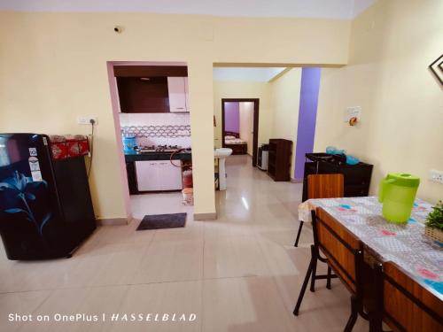 a kitchen and a living room with a refrigerator at DREAMS ABODE studio apartment in Guwahati