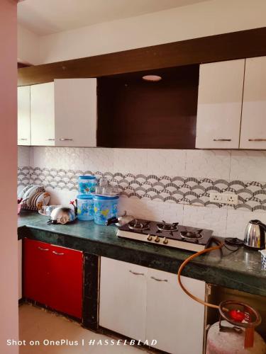 a kitchen with a stove and a counter top at DREAMS ABODE studio apartment in Guwahati