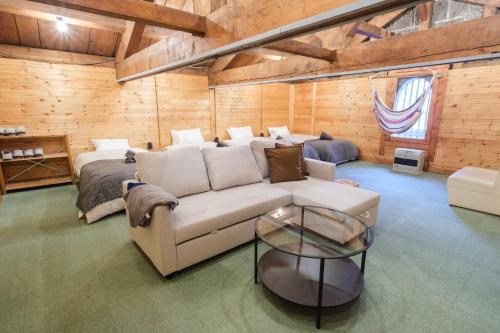 a living room with a couch and a bed at Stone Lodge 小樽 in Kita-hamachō