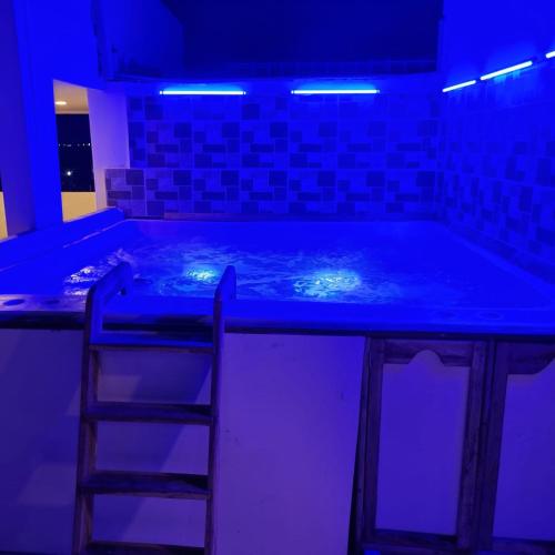 a blue room with a bar with a stool in it at Dreimar Hotel Boutique in Cartagena de Indias