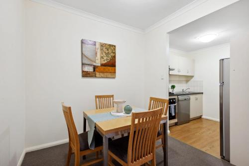 a kitchen and dining room with a table and chairs at 1BRD 1BTH 1PRK - Northbridge Apartment in Perth