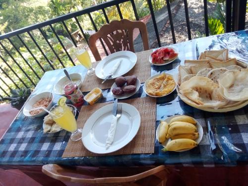 a picnic table with plates of food on it at Forest Rawana homestay Ella in Ella