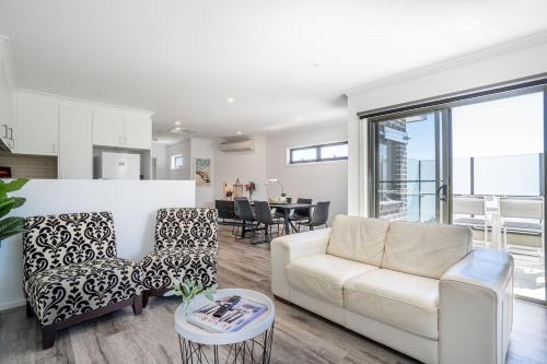 a living room with a couch and a table at The Adams - Heart of Rosebud Retreat for Groups in Rosebud