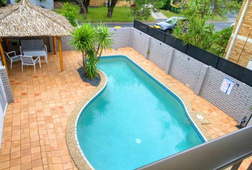 a swimming pool in a backyard with a house at Villa 1 and Villa 2 in Gold Coast