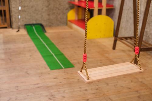 a swing in a room with a green stripe at Stone Lodge 小樽 in Kita-hamachō