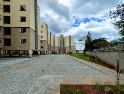 an empty street in a city with tall buildings at Luxury Homes in Nairobi in Athi River