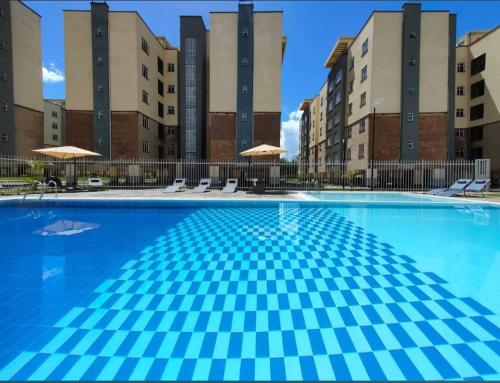 a large swimming pool in front of some buildings at Luxury Homes in Nairobi in Athi River